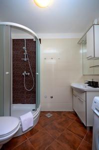 a bathroom with a shower and a toilet and a sink at Apartment Mia in Split