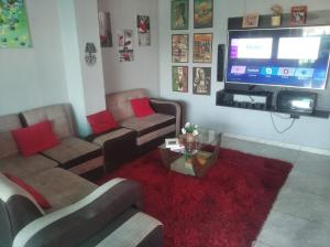 a living room with couches and a flat screen tv at Jack Appart (departamento 2 cuartos y terraza) in Arequipa