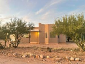 a house in the desert with trees in front of it at Desert Ranch Home 3 Bedroom + Equine Facility in Vail