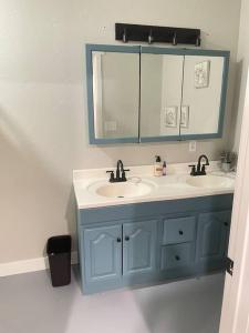 a bathroom with two sinks and a mirror at Desert Ranch Home 3 Bedroom + Equine Facility in Vail