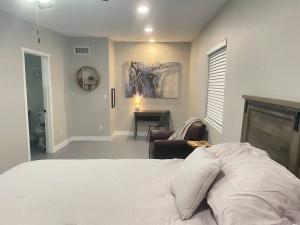 a bedroom with a bed and a chair and a desk at Desert Ranch Home 3 Bedroom + Equine Facility in Vail