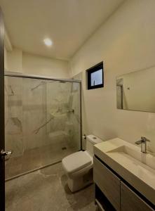 a bathroom with a shower and a toilet and a sink at Torre Q Mazatlán - Departamento cerca del malecón de Mazatlán in Mazatlán +15 photos