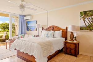a bedroom with a large bed and a window at Islander Resort Oceanfront # 149 in Kapaa