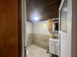 a small bathroom with a toilet and a sink at Cay Suite in Uzungol