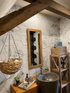 a bathroom with a sink and a mirror at Love Room in Saint-Amand-les-Eaux