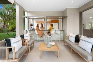 three women sitting at a table in a living room at Witta Circle - Walk to Hastings St & Noosa Beach in Noosa Heads