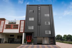 a rendering of a black building with a red door at Super Townhouse 217 The Awadh Airport Near Chaudhary Charan Singh International Airport in Bijnaur