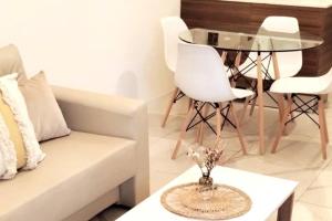 sala de estar con sofá blanco y mesa de cristal en Excelente depto en Rosario en Rosario