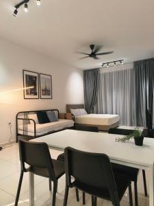 a living room with two beds and a table and chairs at 2BR Beacon Executive Suites @ Georgetown in George Town