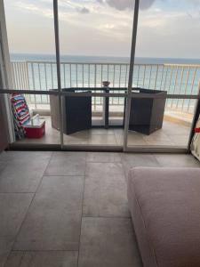 a room with a view of the ocean from a balcony at Ocean Front Condo in Isla Verde! in San Juan