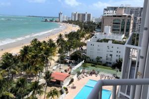 a view of the beach from the balcony of a resort at Beach Front Condo in Isla Verde! in San Juan