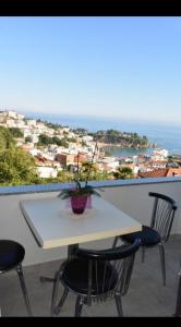 a white table and chairs on a balcony with the ocean at Apartments Hillside in Ulcinj
