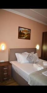 a hotel room with two beds and a night stand at Apartments Hillside in Ulcinj