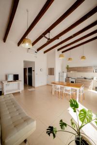 a large living room with a table and a kitchen at La Boya Departamentos in La Paz