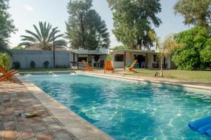 uma piscina com cadeiras e uma casa em Complejo Mis Pumitas em La Banda