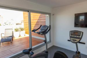 a gym with two exercise bikes in front of a window at Mérit Montevideo Apart & Suites in Montevideo