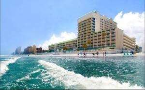a view of a beach with a large building at Oceanfront Condo at Daytona Beach Resort in Daytona Beach