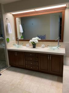 a bathroom with two sinks and a large mirror at Amazing Ocean Front Condo in Rosarito