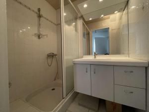 a bathroom with a sink and a shower and a tub at Maison rénovée 5 pièces, jardin clos, à 2 pas de l'océan, pour 10 personnes - Saint-Jean-de-Monts - FR-1-224C-231 in Saint-Jean-de-Monts +25 photos