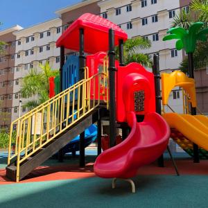 a playground with a slide in front of a building at Apparate Condotel Staycation in Cavite