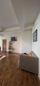 a living room with a couch in the middle of a room at Heschuk Guest House in Leh