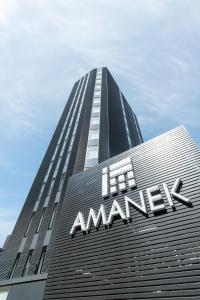 a tall building with an amazon sign on it at HOTEL AMANEK Shinjuku Kabukicho in Tokyo