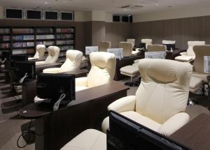 a library with white chairs and desks in a room at Rifure Iwaki Ekimaeten-Male Only in Iwaki