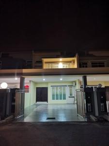 a front view of a house at night at Cozzy26 Homestay in Bintulu