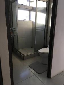 a bathroom with a shower and a toilet at Casa céntrica en San Ramón in San Ramón +6 photos