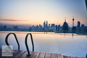 a view of a city skyline from a swimming pool at Regalia Residence @ KLCC View Sky Pool by MC in Kuala Lumpur