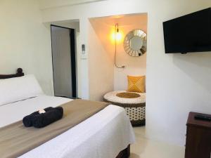 a hotel room with a bed and a mirror at Suva City Accommodation in Suva