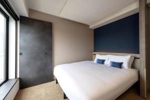 Postel nebo postele na pokoji v ubytování HOTEL AMANEK Shinjuku Kabukicho + 37 fotografií