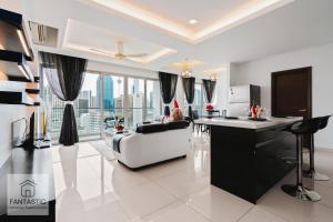 a living room with a couch and a table at Regalia Residence @ KLCC View Sky Pool by MC in Kuala Lumpur