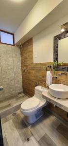 a bathroom with a white toilet and a sink at Departamento Cumbe Mayo in Cajamarca