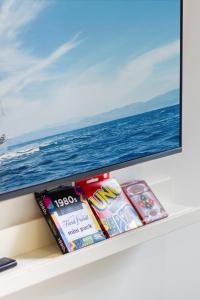 a shelf with a flat screen tv and books at The Majestic retreat 2 bed 2 bath CBD in Christchurch
