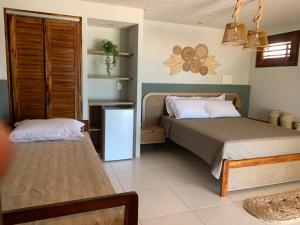 a bedroom with two beds and a table in it at PREÁ ON BEACH in Cruz