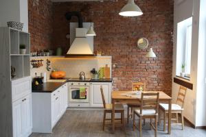 a kitchen with a table and a brick wall at Del Toro Apartment in Skopje