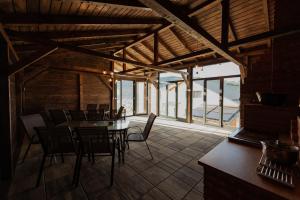 a dining room with a table and chairs in a building at Watra Chalet in Vatra Dornei