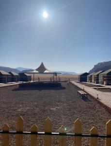 a playground with a tent in the middle of a field at Lukasa camp Wadi Rum in Disah