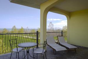 a porch with a table and chairs and a view at Villa Marianna in Vasto