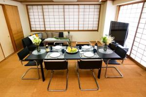 a dining room with a table and chairs at KODAKA Hotel TOKYO in Tokyo