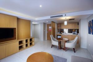 a kitchen and dining room with a table and chairs at Swiss-Belhotel Pondok Indah in Jakarta