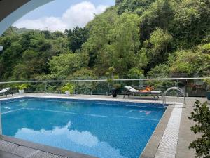 a swimming pool with a view of a mountain at Lynh's Villa in Cat Ba