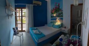 a bedroom with a bed with a blue wall at Garden House in Hora Sfakion