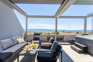 a living room with a couch and a table at Apartments Blue Maris Žnjan in Split