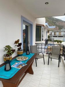 a table and chairs on the balcony of a house at Vintage Guest House in Monemvasia