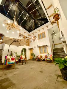 a large living room with chairs and an umbrella at Mistico San Blas Boutique in Cusco