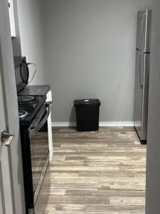 a kitchen with a stove and a refrigerator at Walk to the Cowboys Game! Luxury Apt sleeps 4! in Arlington
