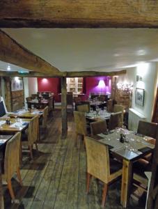 a restaurant with tables and chairs in a room at The Falcon At Hatton in Hatton