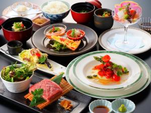 una mesa con platos de comida y tazones de comida en Beppu Fuga, en Beppu